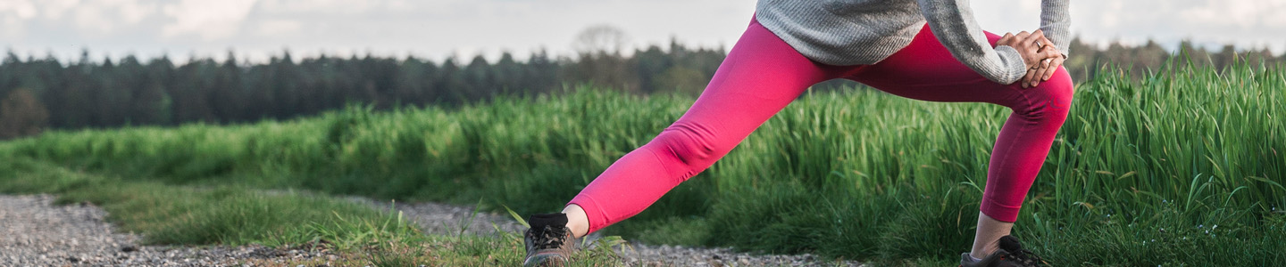 Woman stretching her hip Woman stretching her hip